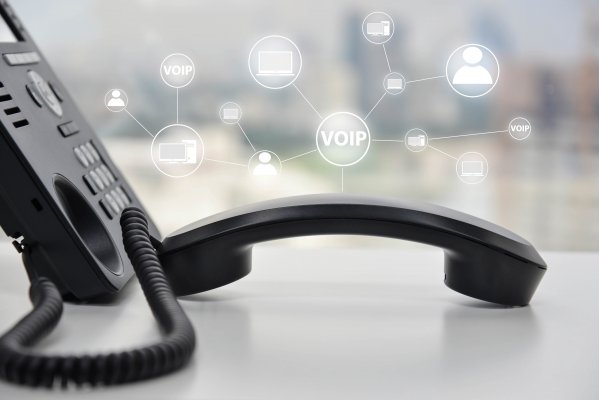 save money voip services benefits black voip phone on desk 